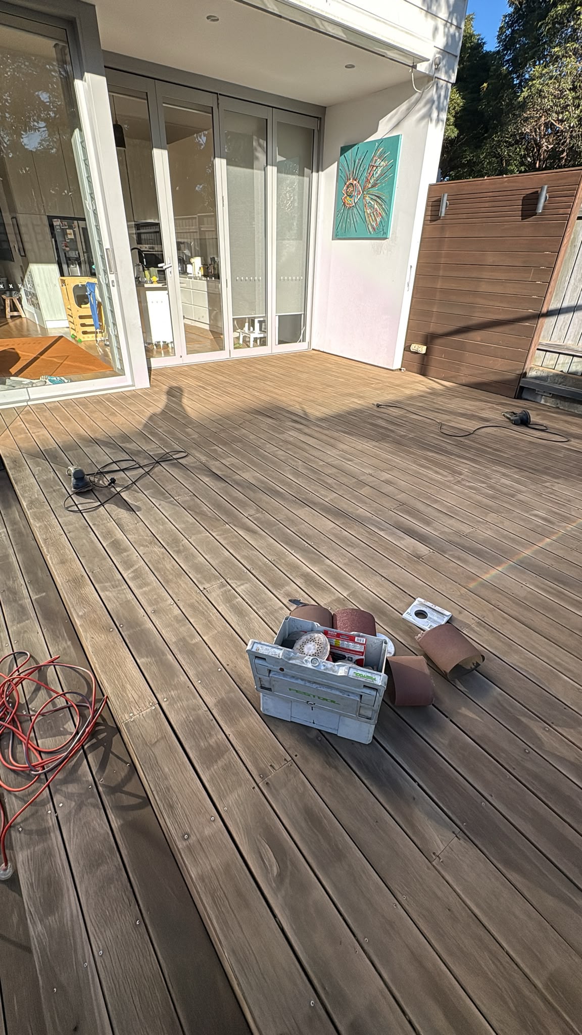 Timber deck being prepared and sanded in Mosman before oiling, showing bare freshly cleaned boards ready for a new coat