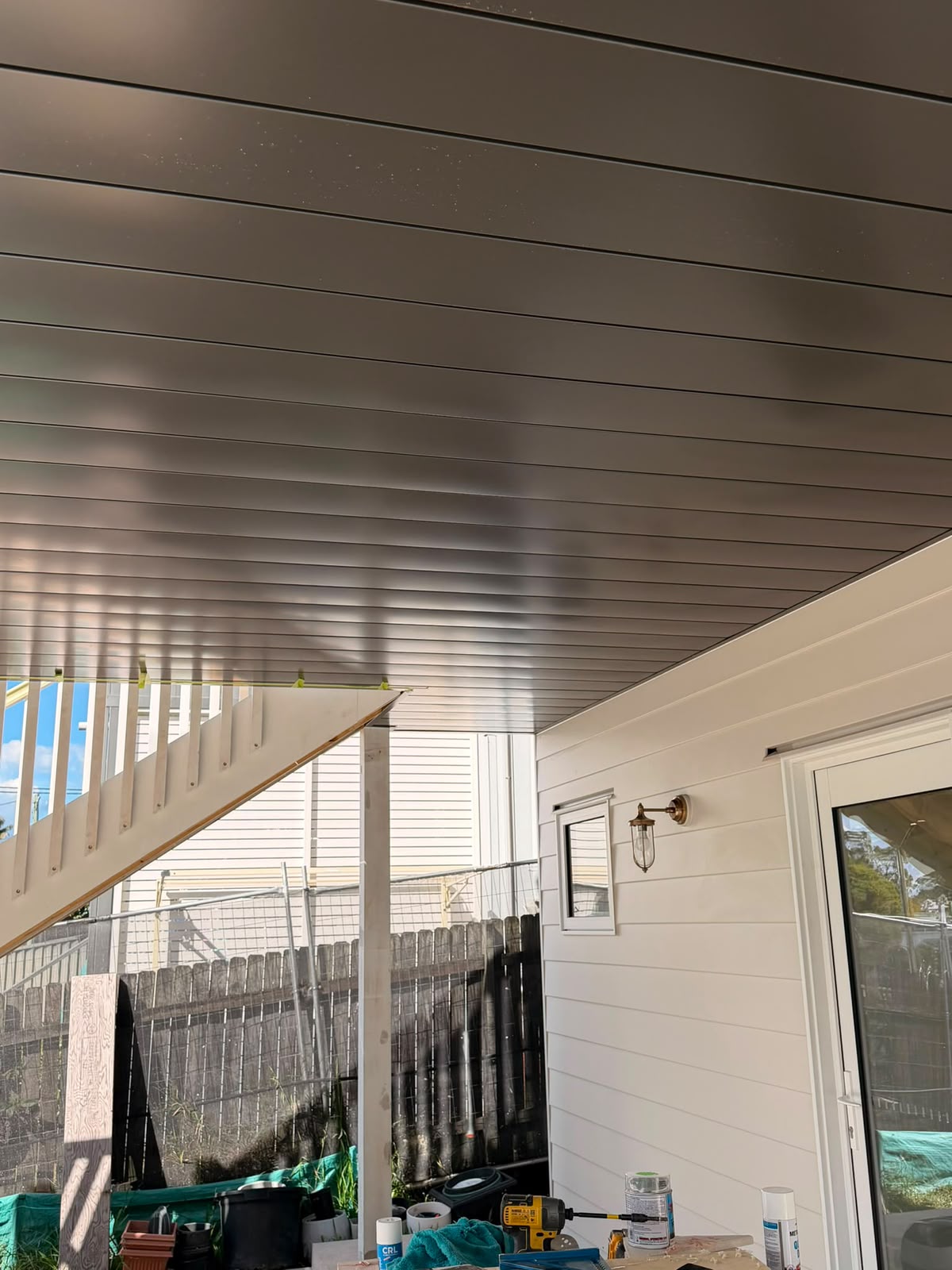 Full view of staircase construction with soffit lining and yard below