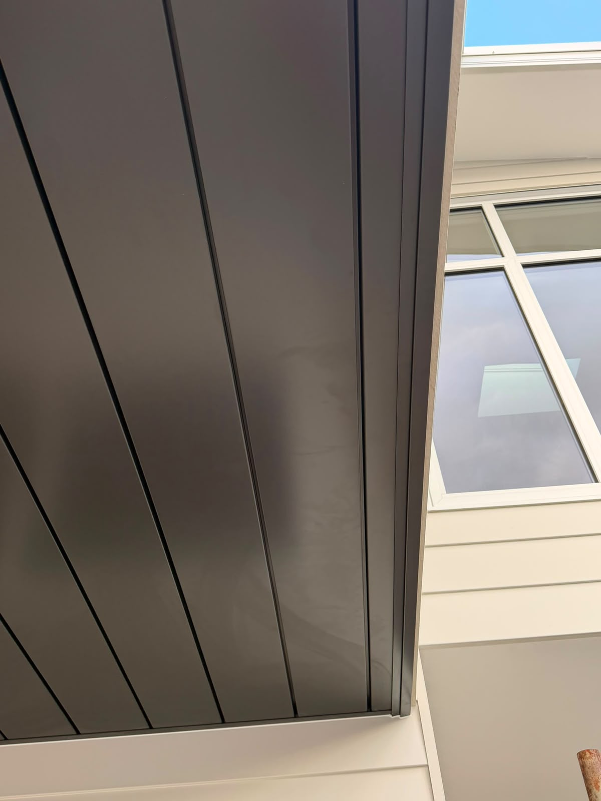 Close-up of soffit lining edge meeting fascia and window trim