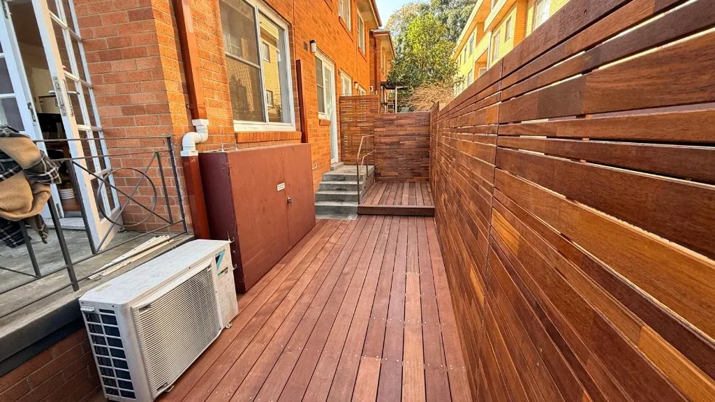 Merbau deck wrapping around AC units and meter boxes in Petersham terrace — 5 Star Decking