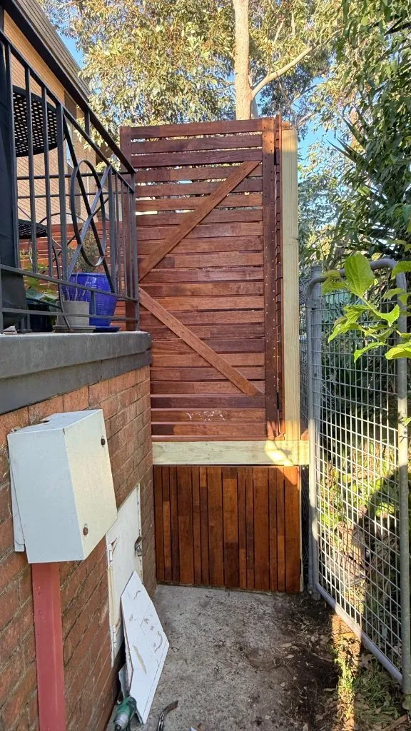 Timber-clad merbau stairs connecting Petersham deck to concrete landing — 5 Star Decking
